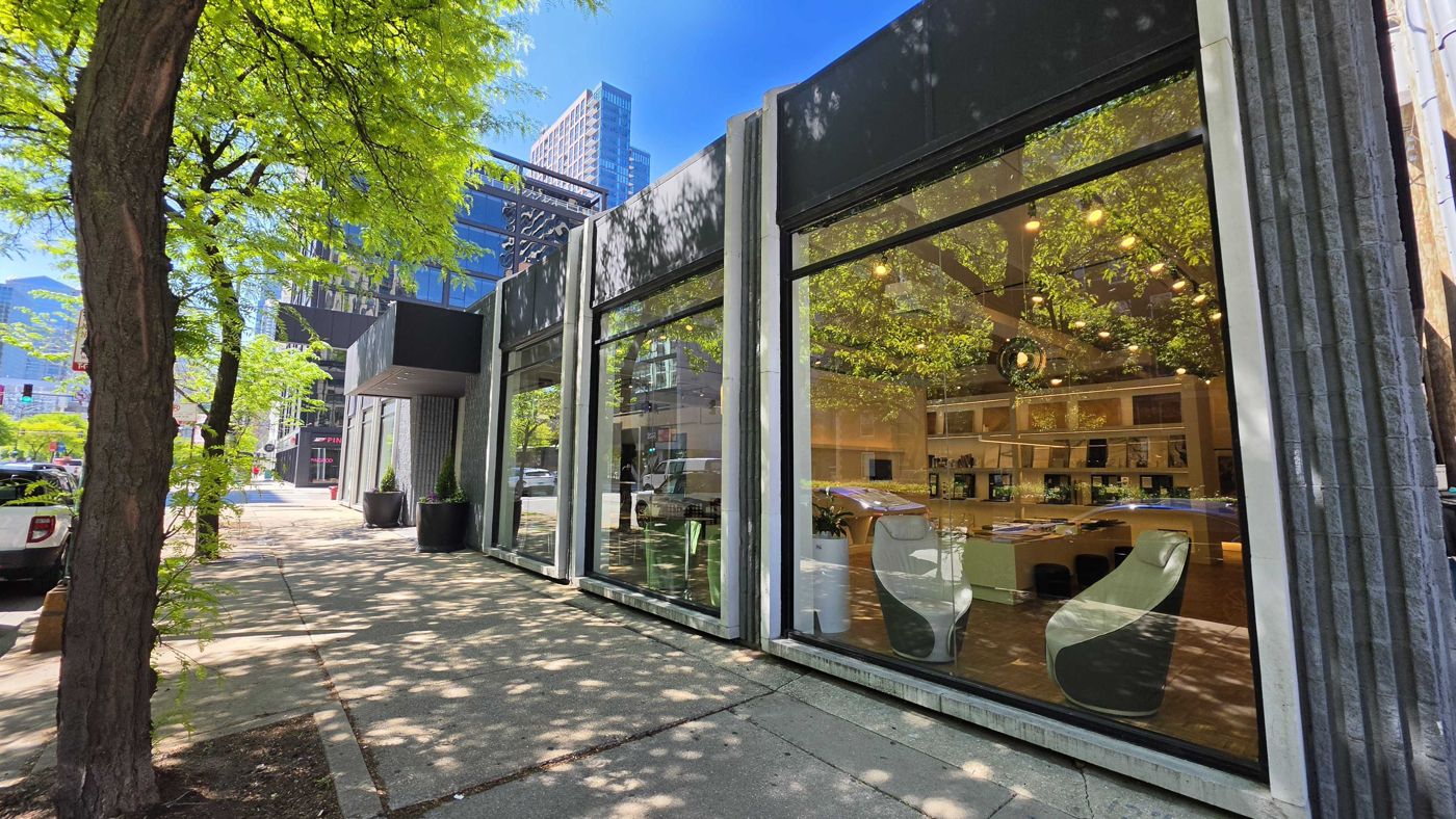 The storefront windows along the sidewalk